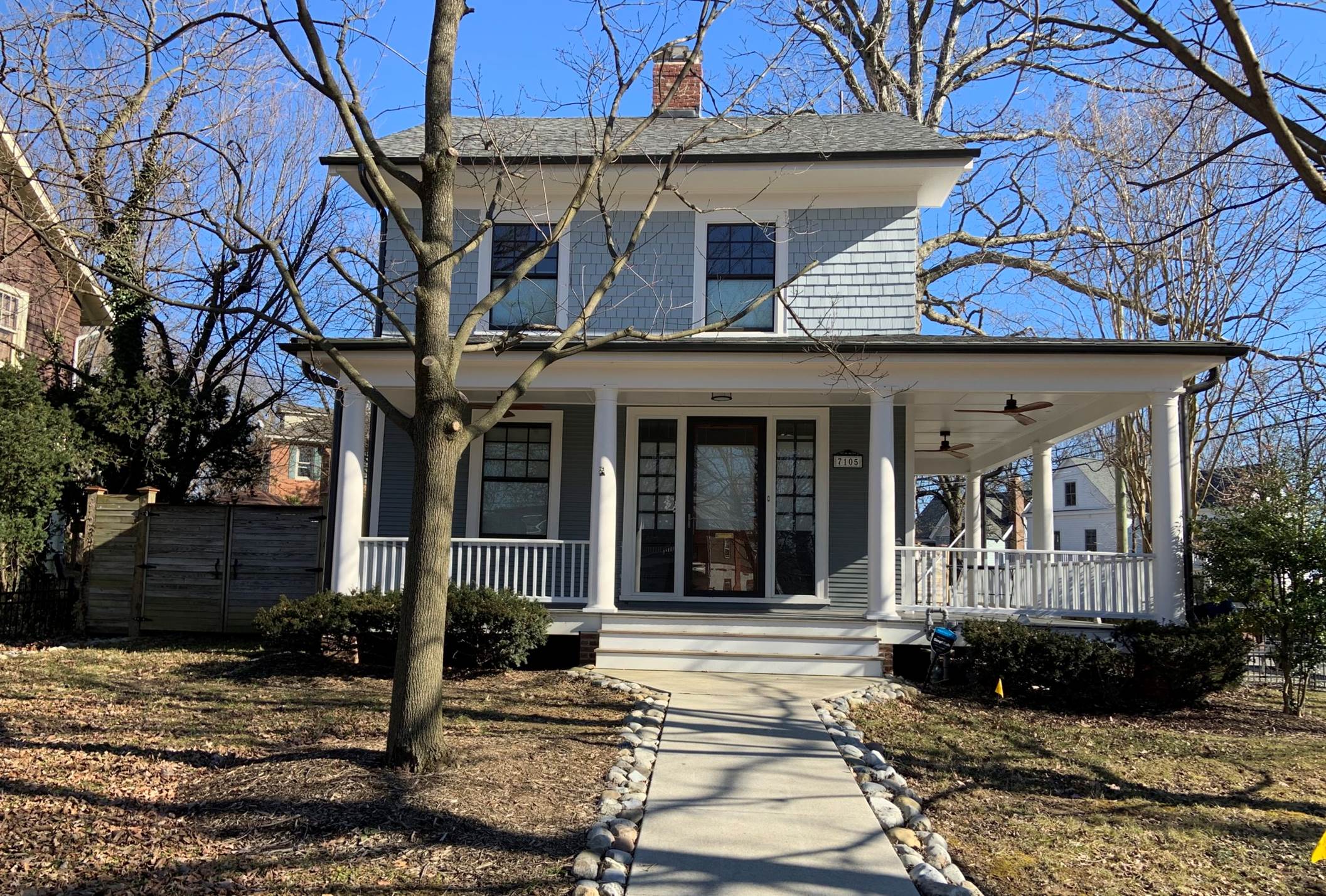 A house with a porch and a walkway

Description automatically generated